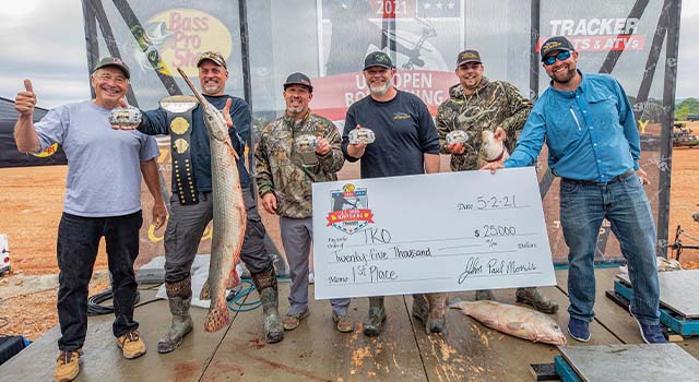 bowfishing team holds up winning fish