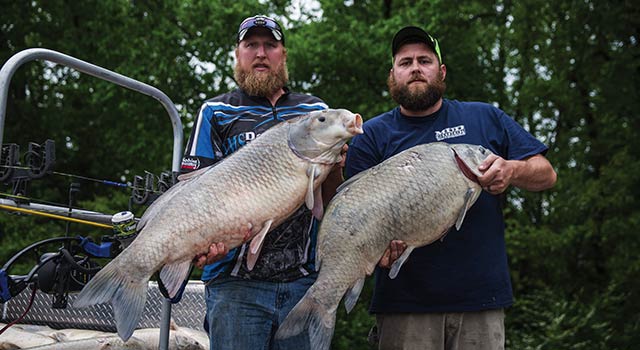 two men holding trophy fish